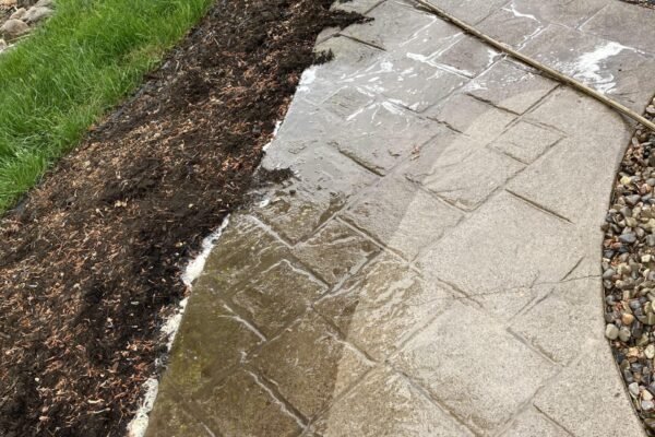 Paver pressure washing with surface cleaner in progress